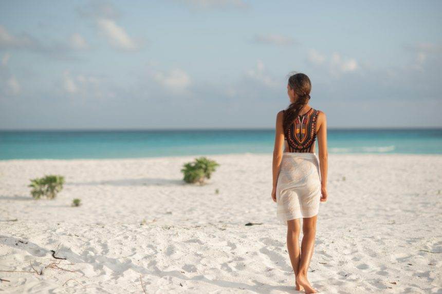 Brunette girl on a luxury vacation on the beach in the Maldives