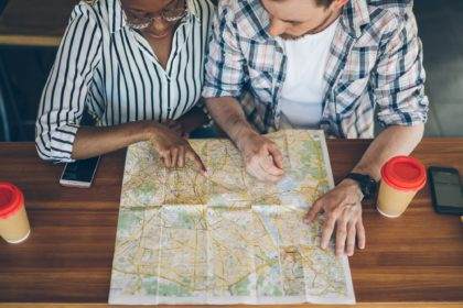 Couple exploring place on map for trip