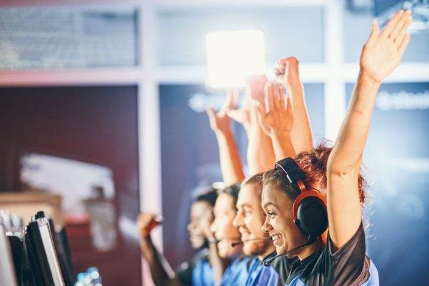 oung multiracial team of happy professional cyber sport gamers celebrating