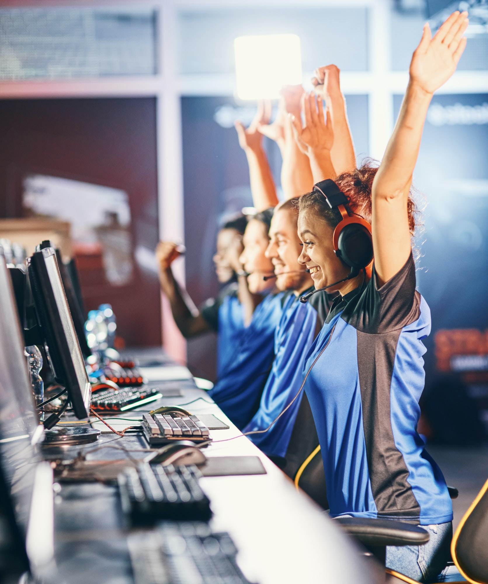 oung multiracial team of happy professional cyber sport gamers celebrating