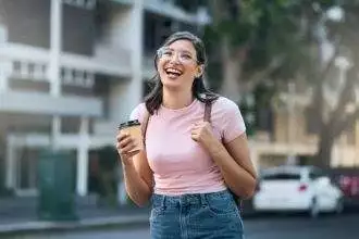 Travel portrait, coffee or woman student in city street or road with freedom on urban adventure in