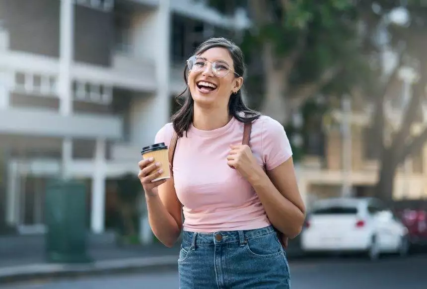 Travel portrait, coffee or woman student in city street or road with freedom on urban adventure in